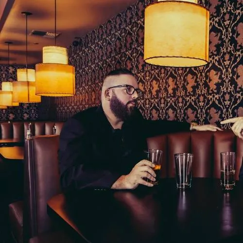Johnny Taylor Jr. portrait in a bar booth